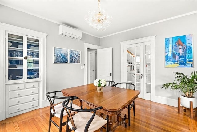 115 Westbourne Ter Unit 1, Brookline, MA 02446 - dining room with a wall mounted AC, light wood-style flooring, a chandelier, and crown molding