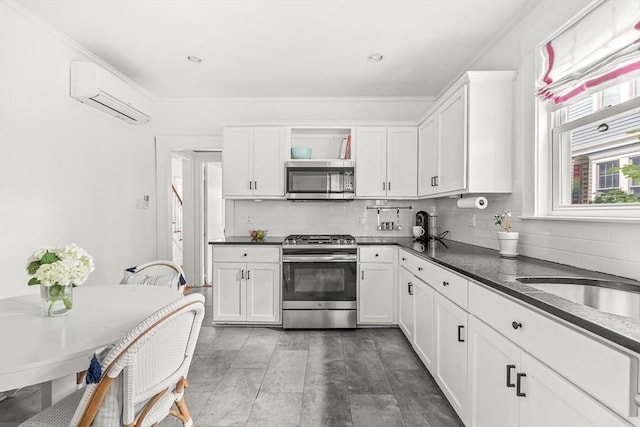 115 Westbourne Ter Unit 1, Brookline, MA 02446 - kitchen with appliances with stainless steel finishes, an AC wall unit, dark countertops, decorative backsplash, and ornamental molding