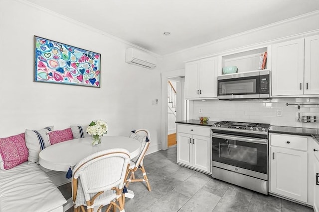 115 Westbourne Ter Unit 1, Brookline, MA 02446 - kitchen featuring appliances with stainless steel finishes, a wall mounted AC, backsplash, white cabinets, and crown molding