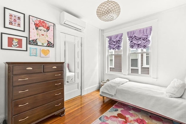 115 Westbourne Ter Unit 1, Brookline, MA 02446 - bedroom with a wall unit AC and wood finished floors