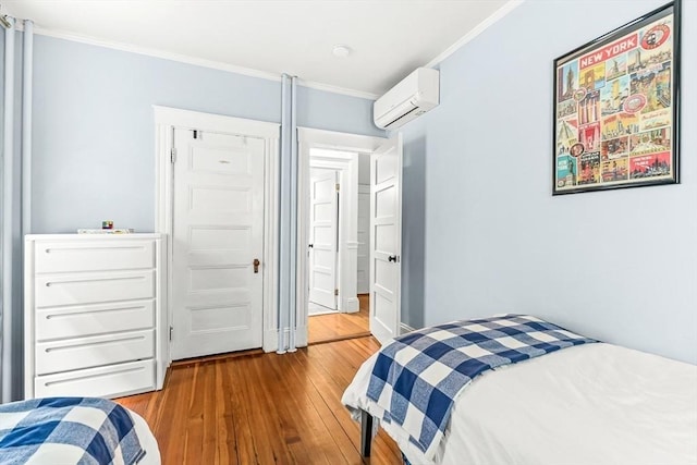 115 Westbourne Ter Unit 1, Brookline, MA 02446 - bedroom featuring hardwood / wood-style flooring, a wall unit AC, and crown molding
