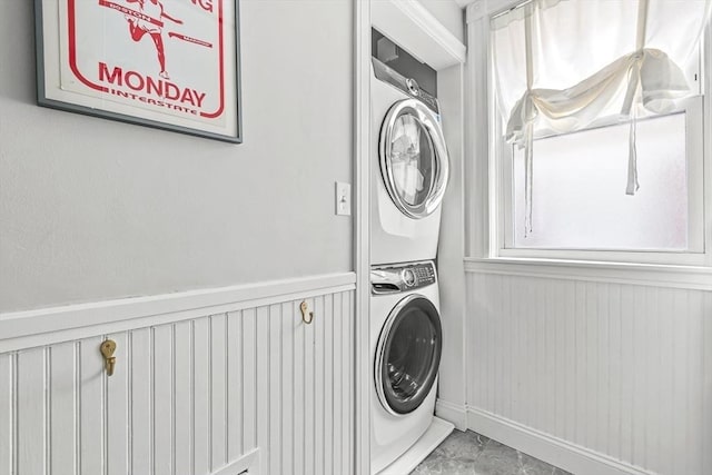 115 Westbourne Ter Unit 1, Brookline, MA 02446 - laundry room featuring stacked washer / dryer and baseboards