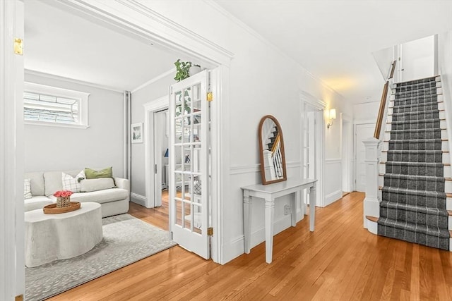 115 Westbourne Ter Unit 1, Brookline, MA 02446 - hallway with wood finished floors, stairway, and crown molding
