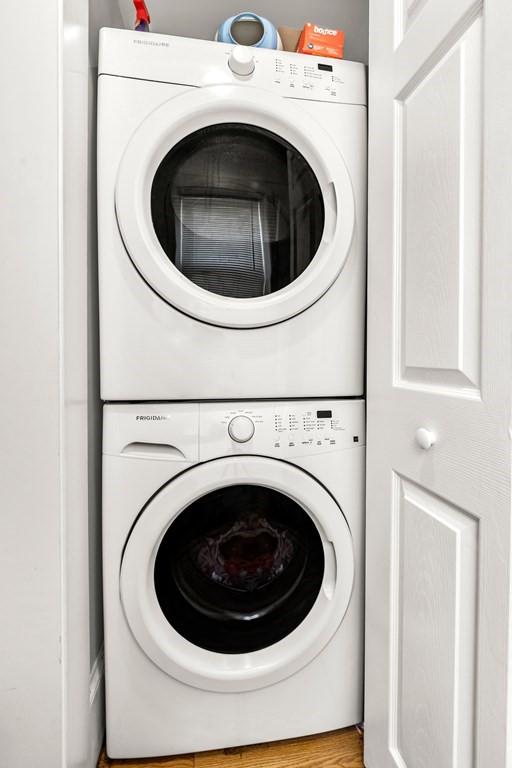 laundry area with stacked washer / dryer and laundry area