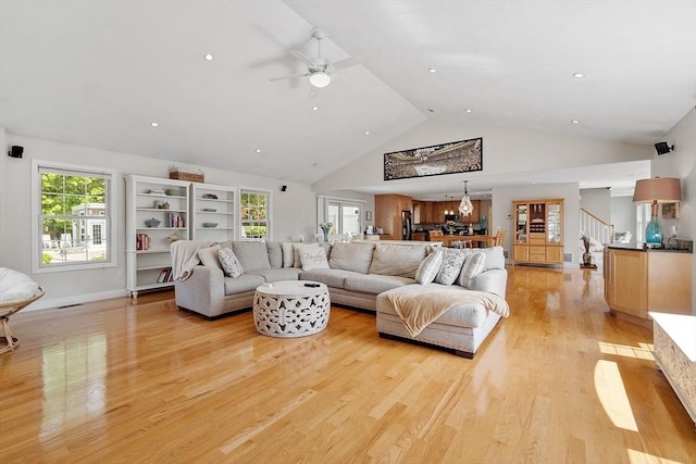 35 Beverly Hill Dr, Shrewsbury, MA 01545 - living room featuring ceiling fan, light wood-style floors, high vaulted ceiling, stairs, and baseboards