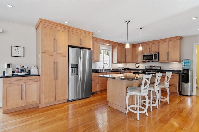 35 Beverly Hill Dr, Shrewsbury, MA 01545 - kitchen with appliances with stainless steel finishes, light wood-style flooring, dark countertops, a kitchen bar, and recessed lighting