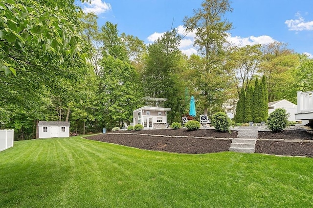 35 Beverly Hill Dr, Shrewsbury, MA 01545 - view of yard featuring an outdoor structure, a storage unit, and view of wooded area