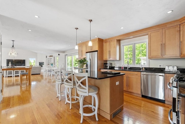 35 Beverly Hill Dr, Shrewsbury, MA 01545 - kitchen with appliances with stainless steel finishes, open floor plan, light wood-style flooring, a center island, and a kitchen bar