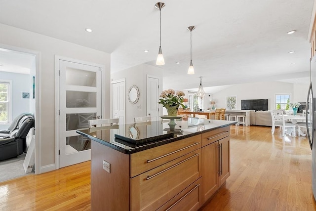 35 Beverly Hill Dr, Shrewsbury, MA 01545 - kitchen featuring open floor plan, light wood-style flooring, a center island, pendant lighting, and brown cabinets