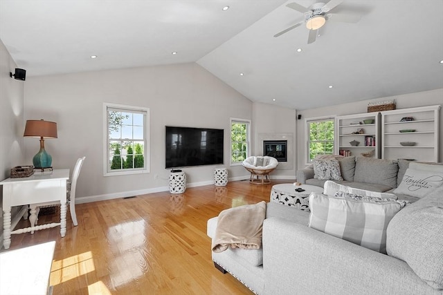 35 Beverly Hill Dr, Shrewsbury, MA 01545 - living area with a ceiling fan, light wood-style floors, high vaulted ceiling, a glass covered fireplace, and baseboards