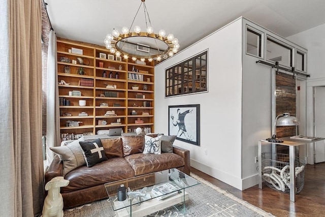 172-178 Green St Unit 1, Boston, MA 02130 - living area with baseboards, a barn door, wood finished floors, built in shelves, and a chandelier