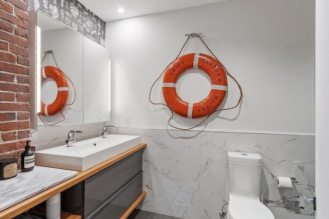 172-178 Green St Unit 1, Boston, MA 02130 - bathroom with tile walls, vanity, wainscoting, and toilet