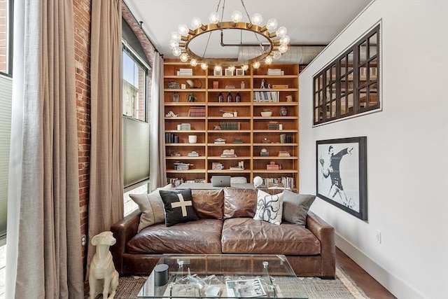 172-178 Green St Unit 1, Boston, MA 02130 - sitting room featuring a chandelier, baseboards, wood finished floors, and built in features