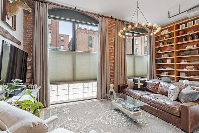 172-178 Green St Unit 1, Boston, MA 02130 - living area with a chandelier, built in shelves, and brick wall