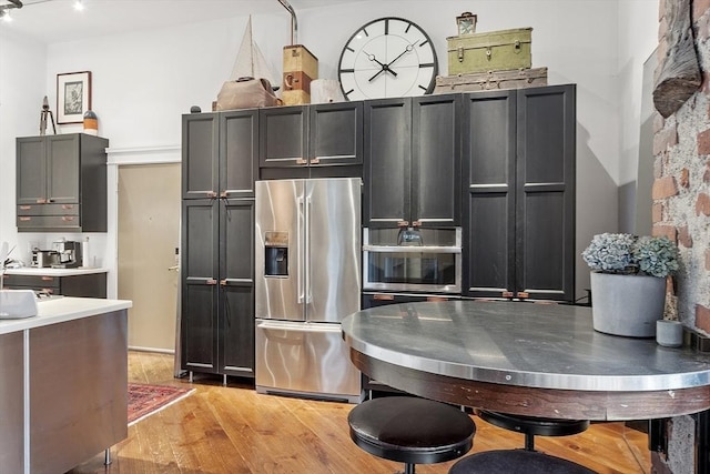 172-178 Green St Unit 1, Boston, MA 02130 - kitchen featuring stainless steel fridge, light wood finished floors, and light countertops