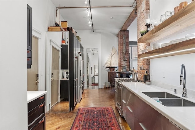 172-178 Green St Unit 1, Boston, MA 02130 - kitchen featuring a sink, light countertops, light wood-style floors, gas range, and open shelves