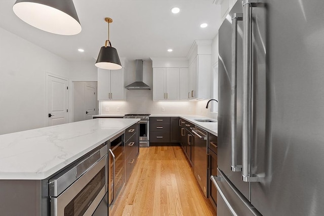 LOT16 Rawson Farm, Mendon, MA 01756 - kitchen featuring wall chimney exhaust hood, stainless steel appliances, a kitchen island, tasteful backsplash, and a sink