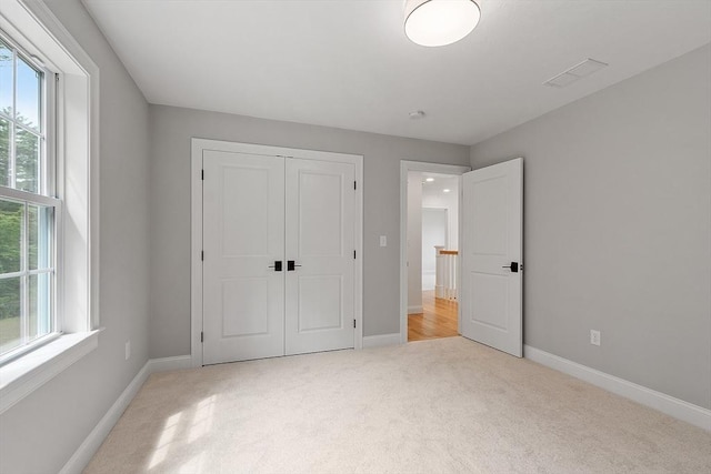 LOT16 Rawson Farm, Mendon, MA 01756 - unfurnished bedroom featuring a closet, light carpet, baseboards, and visible vents
