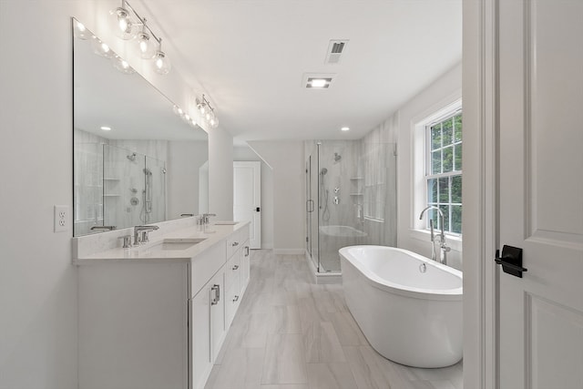 bathroom with vanity and shower with separate bathtub