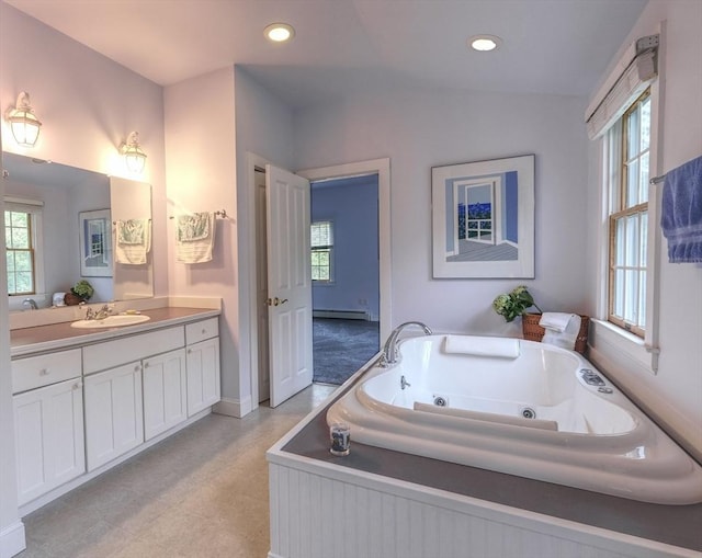 250 S Eastham St, Eastham, MA 02642 - full bath with vanity, a jetted tub, a baseboard heating unit, recessed lighting, and baseboards