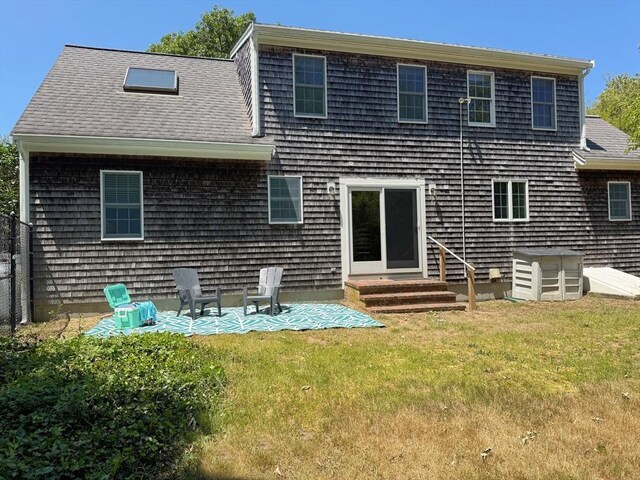 250 S Eastham St, Eastham, MA 02642 - back of house featuring entry steps, a yard, a patio, and roof with shingles