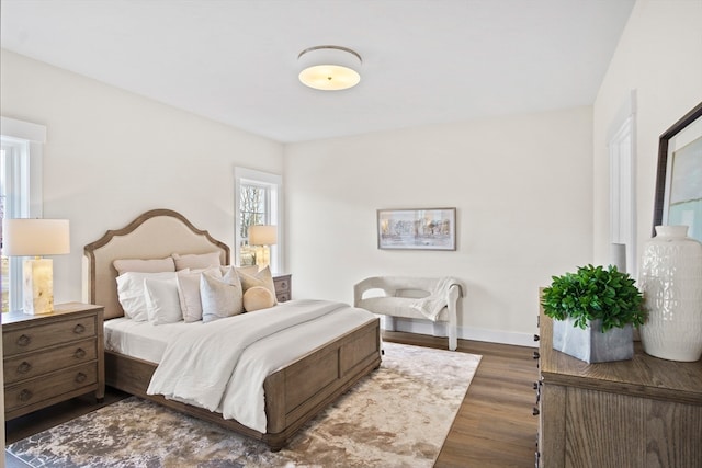 bedroom with dark wood-type flooring