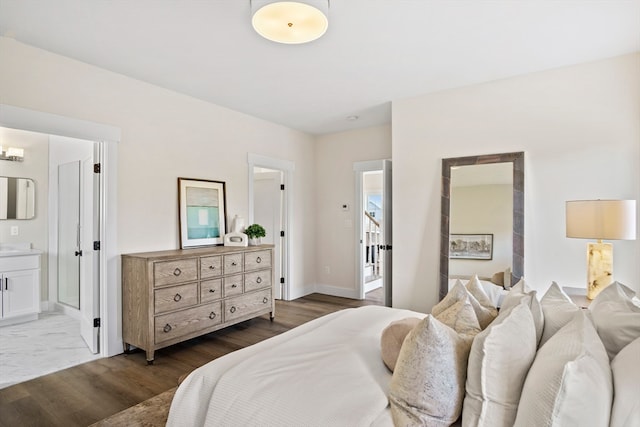 bedroom featuring connected bathroom and dark hardwood / wood-style floors