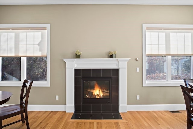 interior space with plenty of natural light, a fireplace, and light hardwood / wood-style floors