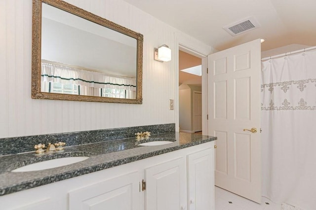 bathroom with vanity and tile patterned flooring