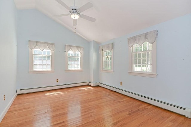 empty room with baseboard heating, ceiling fan, vaulted ceiling, and light hardwood / wood-style floors