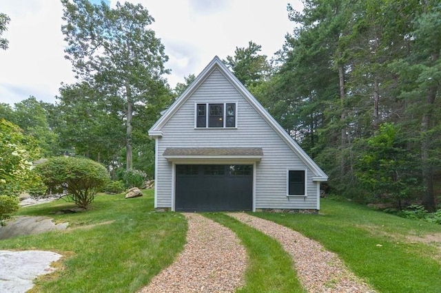 view of side of property with a garage and a yard