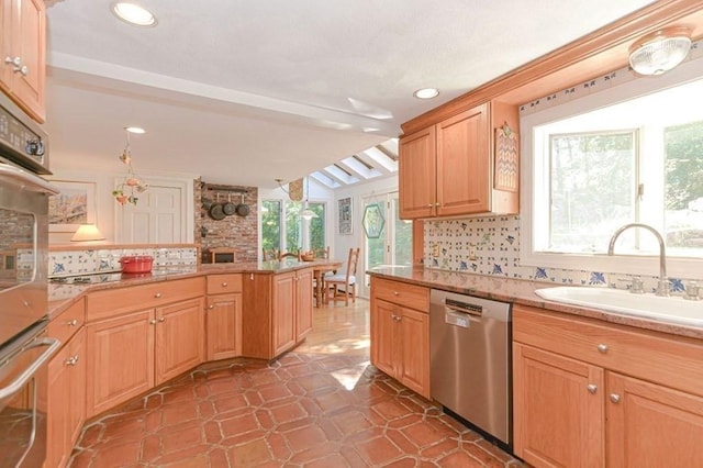 kitchen featuring plenty of natural light, dishwasher, sink, and backsplash