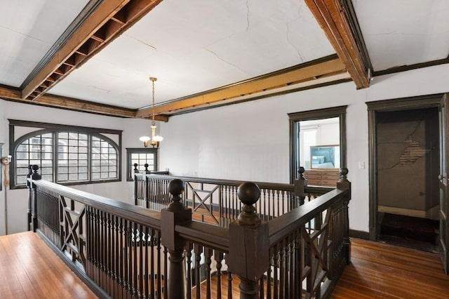 corridor featuring a notable chandelier and dark hardwood / wood-style floors