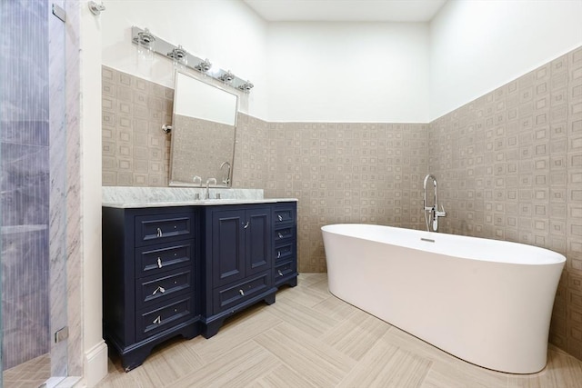515 Centre St Unit 2, Newton, MA 02458 - bathroom with a freestanding bath, vanity, tile walls, a shower stall, and wainscoting