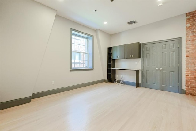 515 Centre St Unit 2, Newton, MA 02458 - unfurnished living room with light wood-type flooring, baseboards, recessed lighting, and brick wall