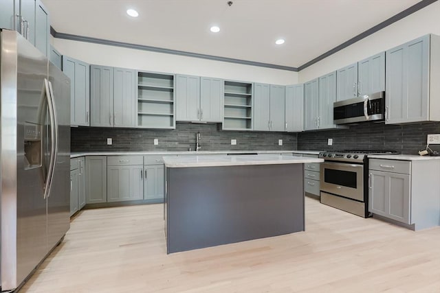 515 Centre St Unit 2, Newton, MA 02458 - kitchen featuring appliances with stainless steel finishes, open shelves, crown molding, a sink, and decorative backsplash
