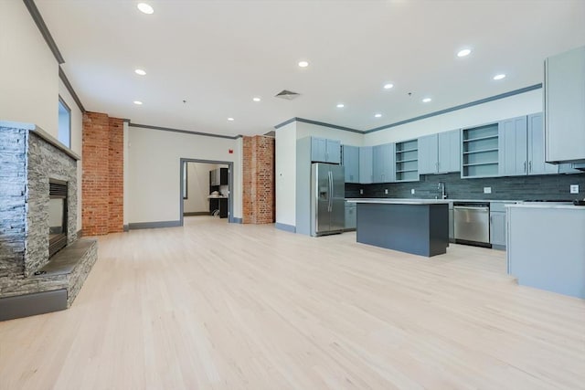 515 Centre St Unit 2, Newton, MA 02458 - kitchen featuring stainless steel appliances, open shelves, open floor plan, a kitchen island, and backsplash