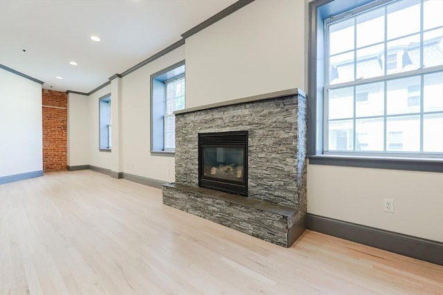 515 Centre St Unit 2, Newton, MA 02458 - unfurnished living room featuring ornamental molding, wood finished floors, a stone fireplace, baseboards, and recessed lighting