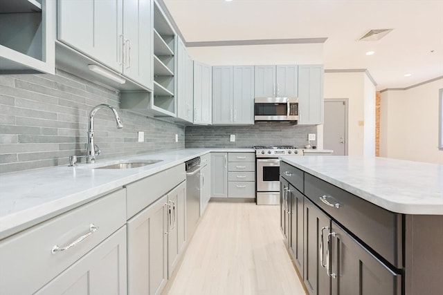 515 Centre St Unit 2, Newton, MA 02458 - kitchen with stainless steel appliances, a sink, open shelves, backsplash, and light stone countertops