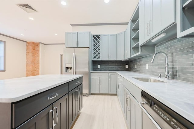 515 Centre St Unit 2, Newton, MA 02458 - kitchen with refrigerator with ice dispenser, dishwasher, a sink, open shelves, and decorative backsplash