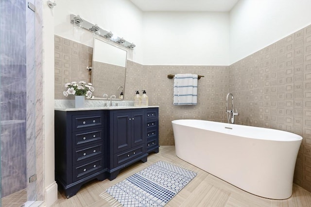 515 Centre St Unit 2, Newton, MA 02458 - bathroom with a freestanding tub, vanity, tile walls, a wainscoted wall, and a stall shower