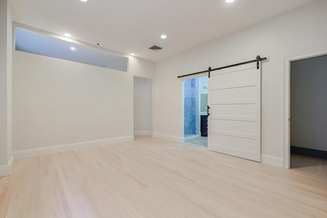 515 Centre St Unit 2, Newton, MA 02458 - spare room featuring a barn door, wood finished floors, recessed lighting, and baseboards