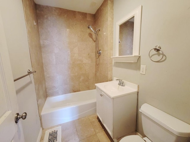 full bathroom with tiled shower / bath, vanity, toilet, and tile patterned floors