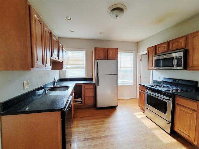 kitchen featuring sink, stainless steel appliances, and light wood-type flooring