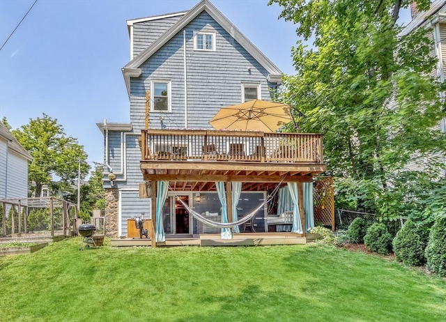 rear view of house featuring a wooden deck