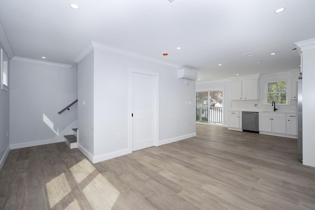 161 Sumner St Unit 1, Quincy, MA 02169 - unfurnished living room featuring an AC wall unit, recessed lighting, ornamental molding, baseboards, and a sink