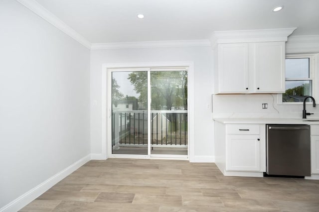 161 Sumner St Unit 1, Quincy, MA 02169 - kitchen with stainless steel dishwasher, light countertops, white cabinetry, baseboards, and a sink