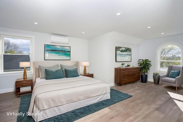 161 Sumner St Unit 1, Quincy, MA 02169 - bedroom featuring a wall mounted air conditioner, light wood-type flooring, baseboards, and recessed lighting