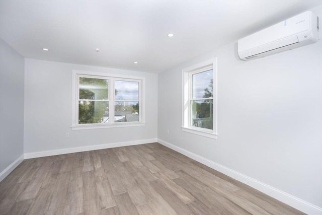 161 Sumner St Unit 1, Quincy, MA 02169 - unfurnished room featuring a wall mounted air conditioner, light wood-style flooring, baseboards, and recessed lighting