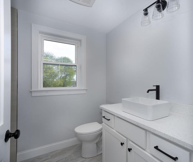 161 Sumner St Unit 1, Quincy, MA 02169 - bathroom with vanity, toilet, and baseboards